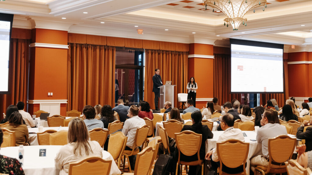 Breakout presenters on stage in front of an audience at Medallia Experience '25